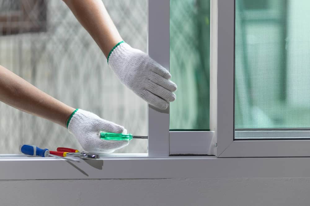 Fixing the window frame with precision and care.