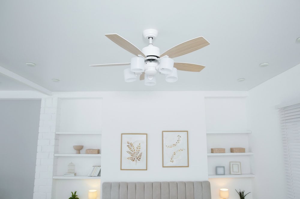 Modern elegance meets cozy comfort—this stylish ceiling fan completes the serene aesthetic of a beautifully designed bedroom.