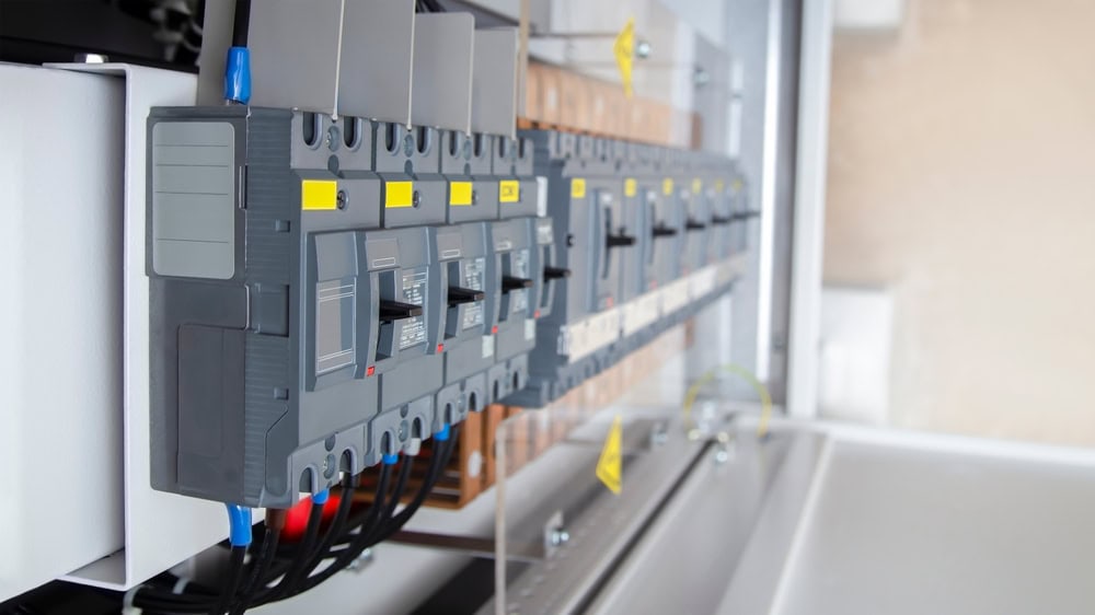 A close-up view of an electrical panel with circuit breakers, showcasing the intricate wiring and robust design.