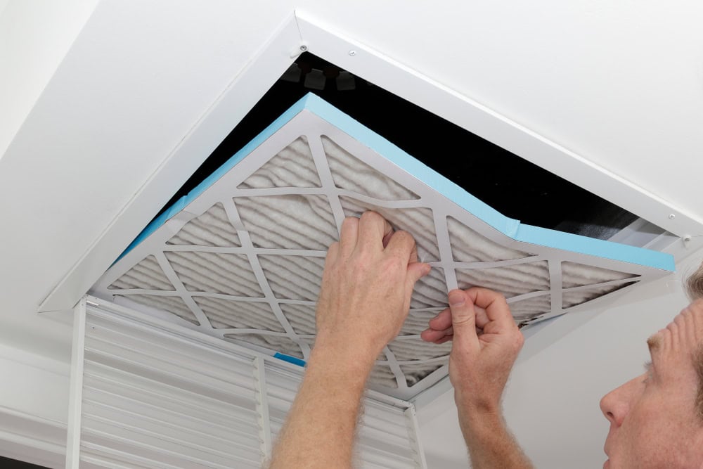 Changing the air filter for better indoor air quality