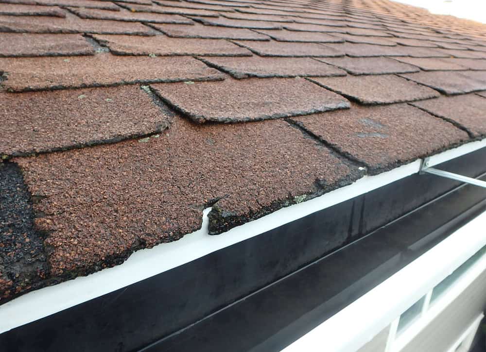 Worn-out shingles and cracked edges—time for a roof repair!