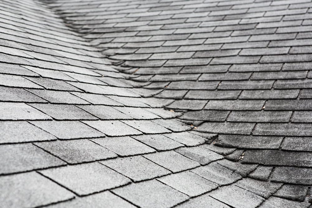 Roof damage: Asphalt shingles in need of repair.