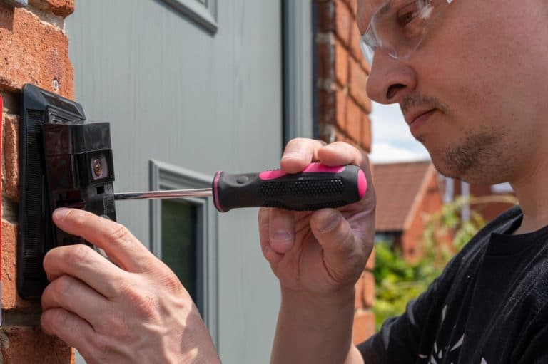 Installing a smart doorbell with precision and care.