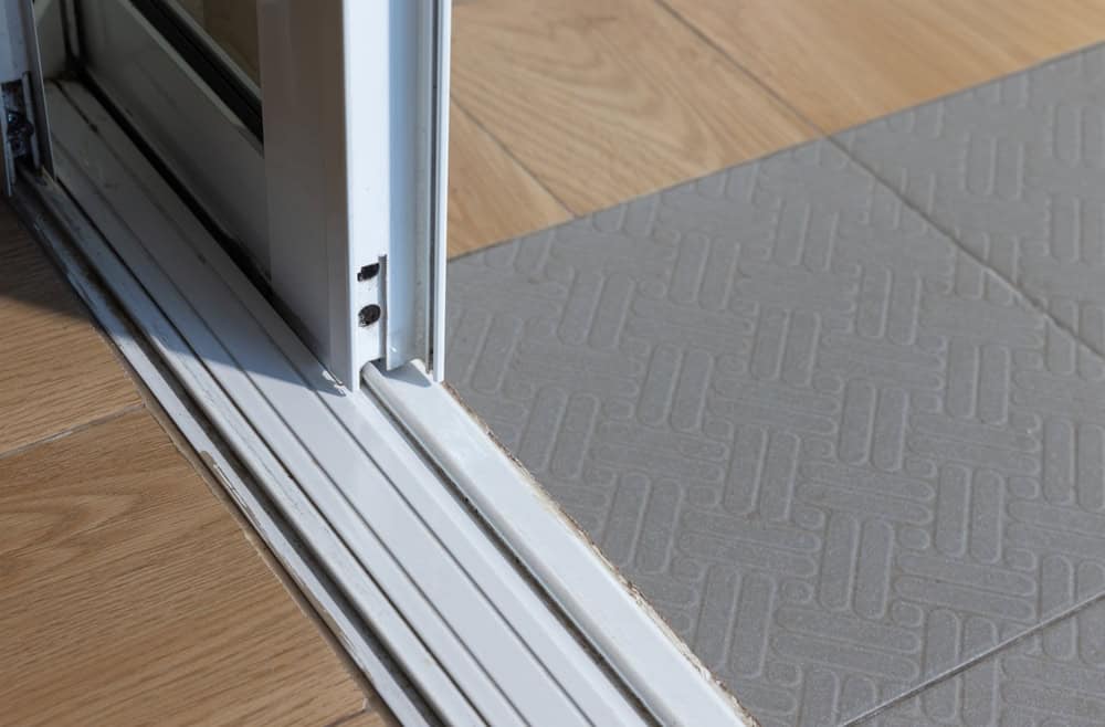Seamless transition: Sliding door connecting wood and tile flooring.