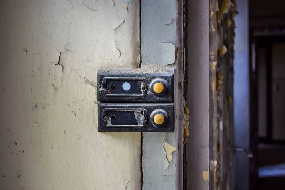 Faded calls of the past—rusted doorbells in an abandoned space.