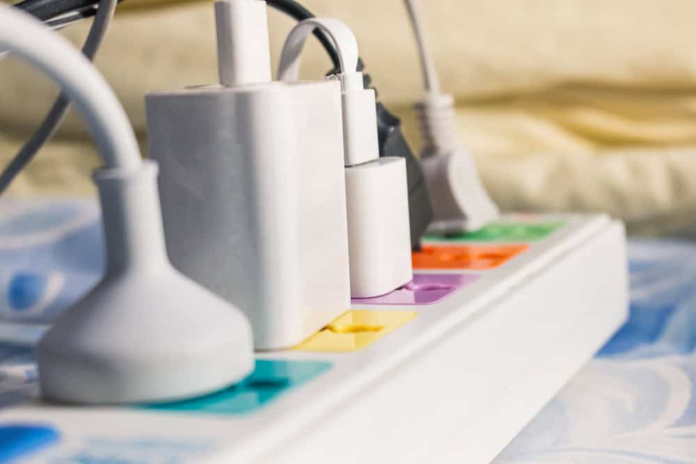 A colorful surge protector powers multiple devices.