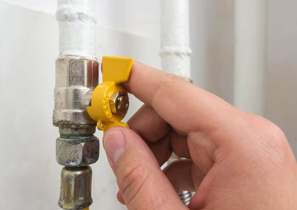 Adjusting the gas valve with precision and care.