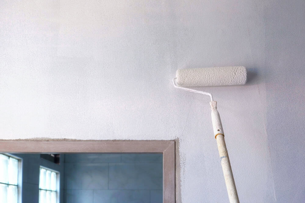 Fresh coat of paint transforming a room with a steady hand and a roller brush.