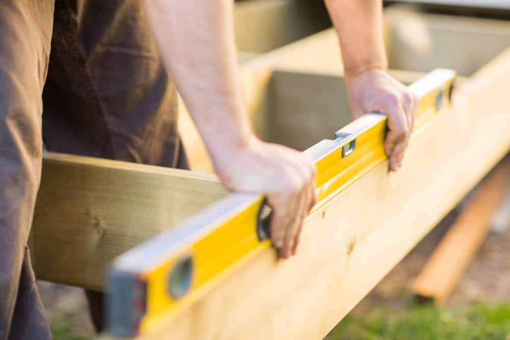 Leveling the wooden frame with precision and care.