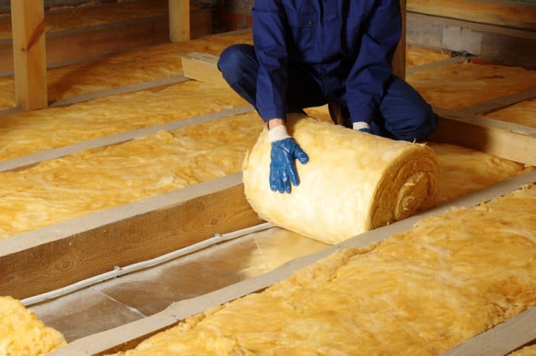 Installing insulation for a warmer, energy-efficient home.