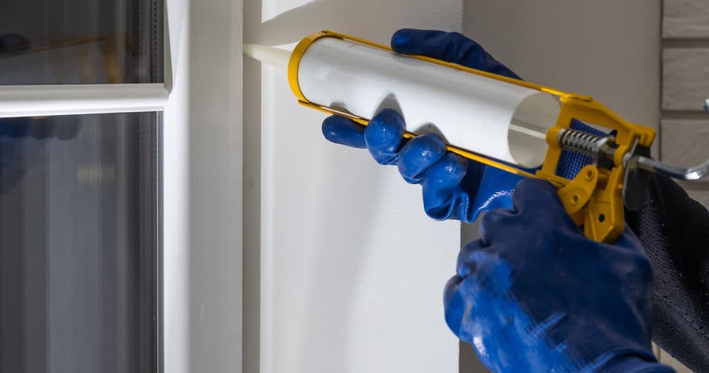 Applying caulk around a window frame