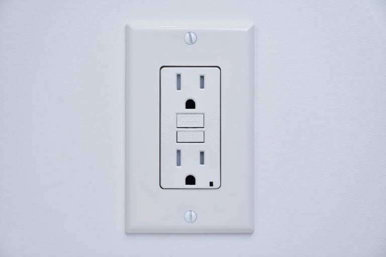 A modern GFCI electrical outlet with reset and test buttons, ensuring safety in your home.