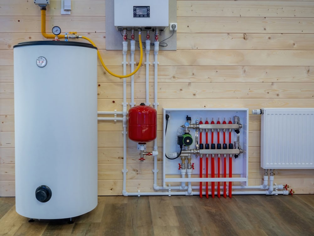 Modern home heating system with a boiler, pressure tank, and underfloor heating manifold. 🔥🏡 #EfficientHeating