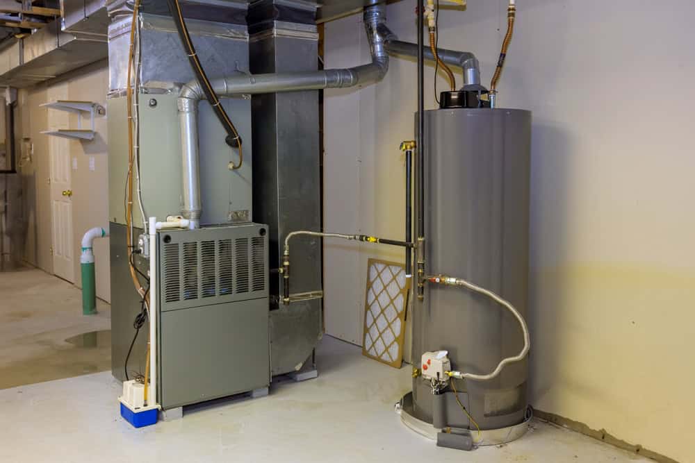 Home heating and hot water system: a furnace and water heater in a clean basement.