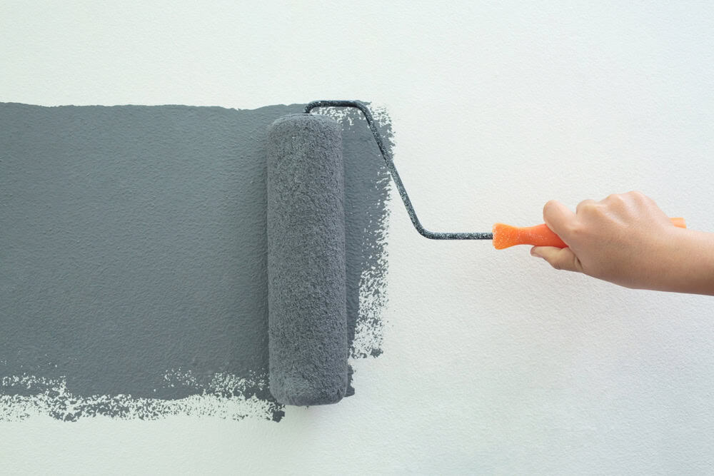 Painting the wall with a fresh coat of grey.