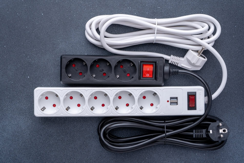 A close-up of two power strips with European plugs.