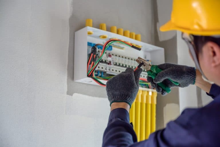 Electrician at work: expertly wiring a circuit breaker panel for a safe and efficient electrical system.