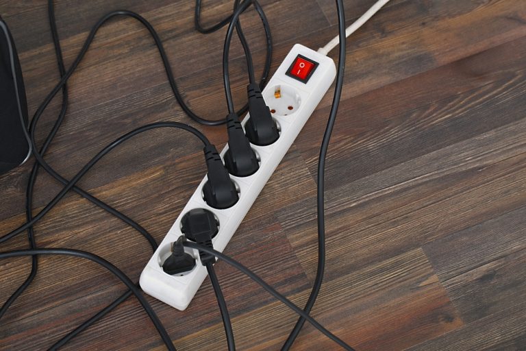 Power strip overload on wood floor.