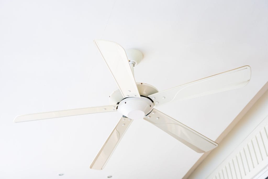 White ceiling fan mounted on a clean white ceiling, simple and minimal design