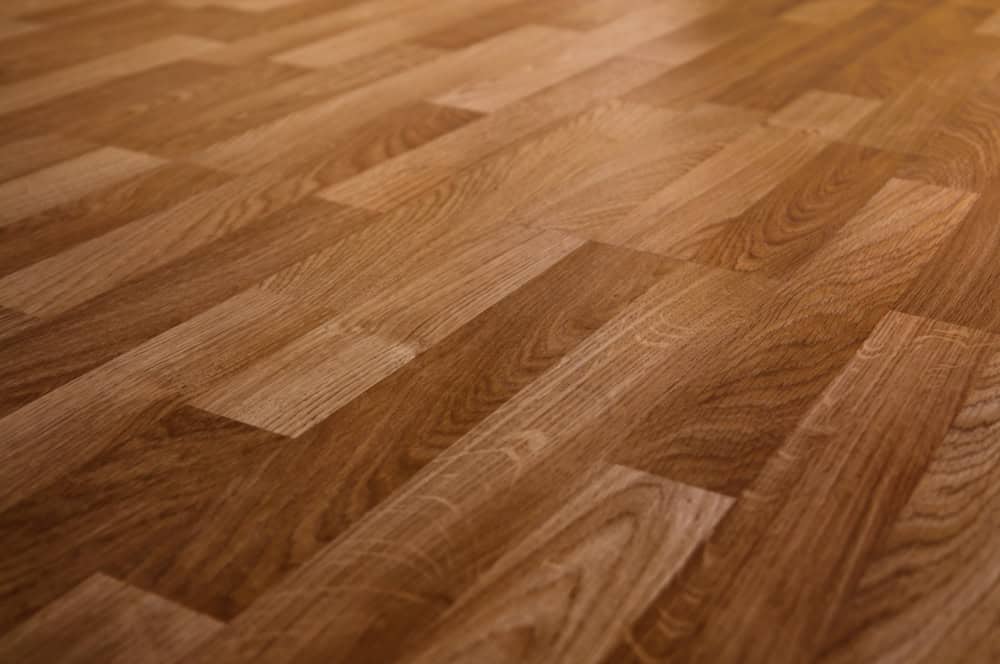 Warm-toned oak wood parquet flooring with a smooth, polished finish.