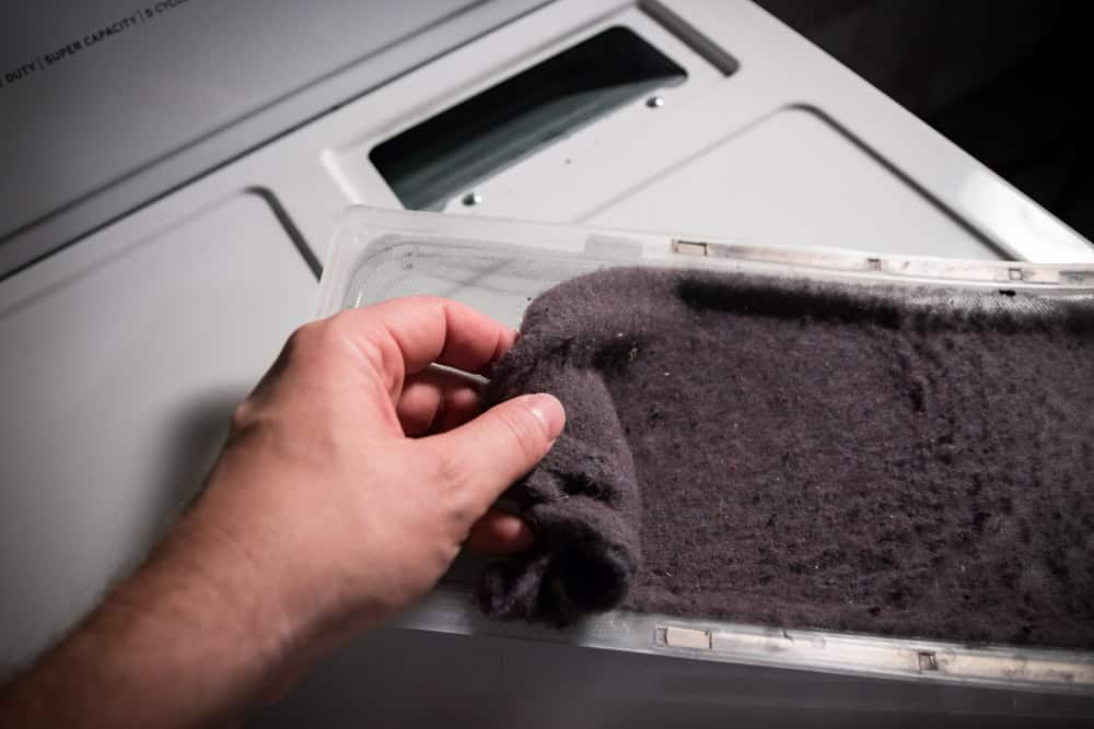 Cleaning the lint trap—an essential step for dryer safety and efficiency.
