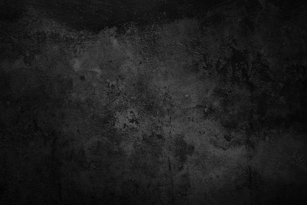 Dark textured concrete wall with a grungy, weathered surface