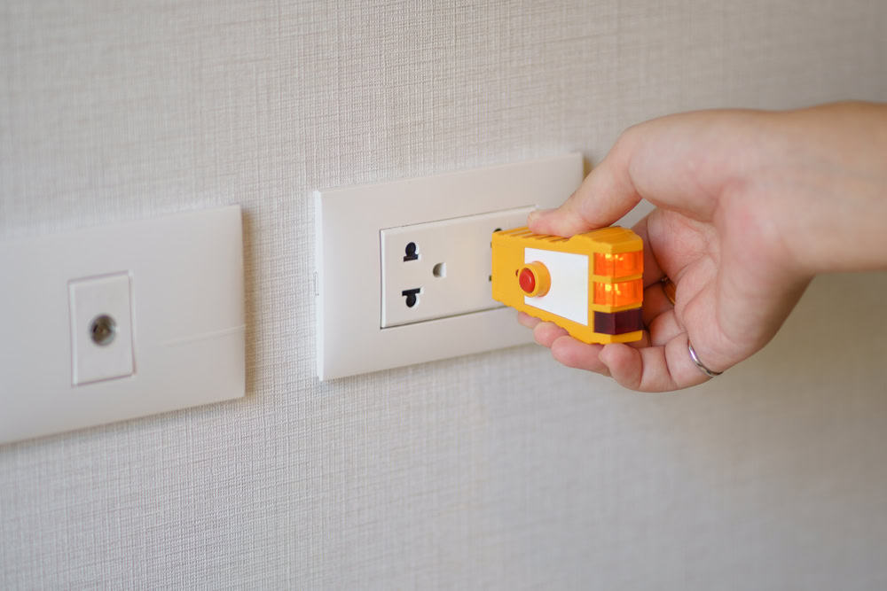 Testing the power outlet with a voltage tester.