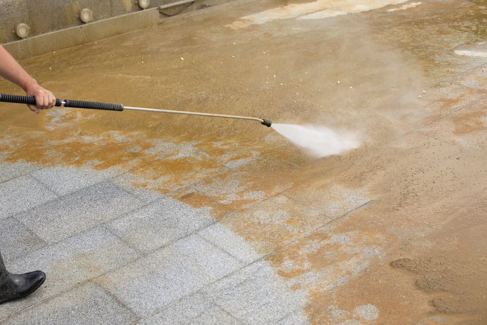 High-pressure cleaning reveals the true color of the pavement.