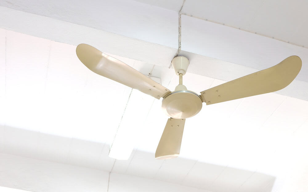 Vintage ceiling fan against a bright white ceiling.