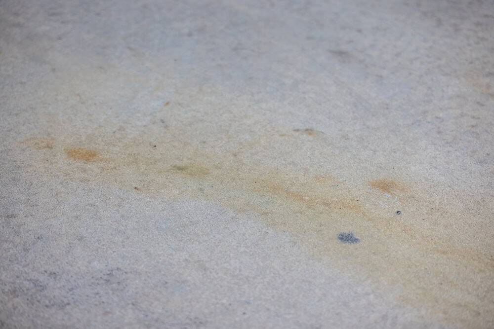 A stain on a weathered concrete surface.