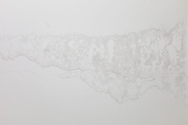 Water damage stains and peeling paint.
