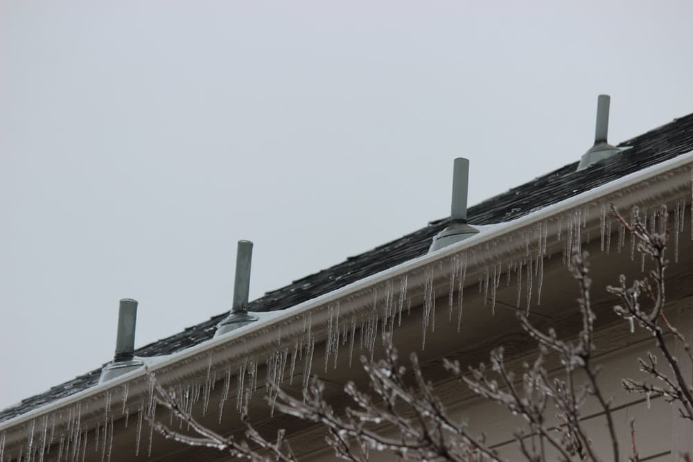Icicles hang from a rooftop edge.