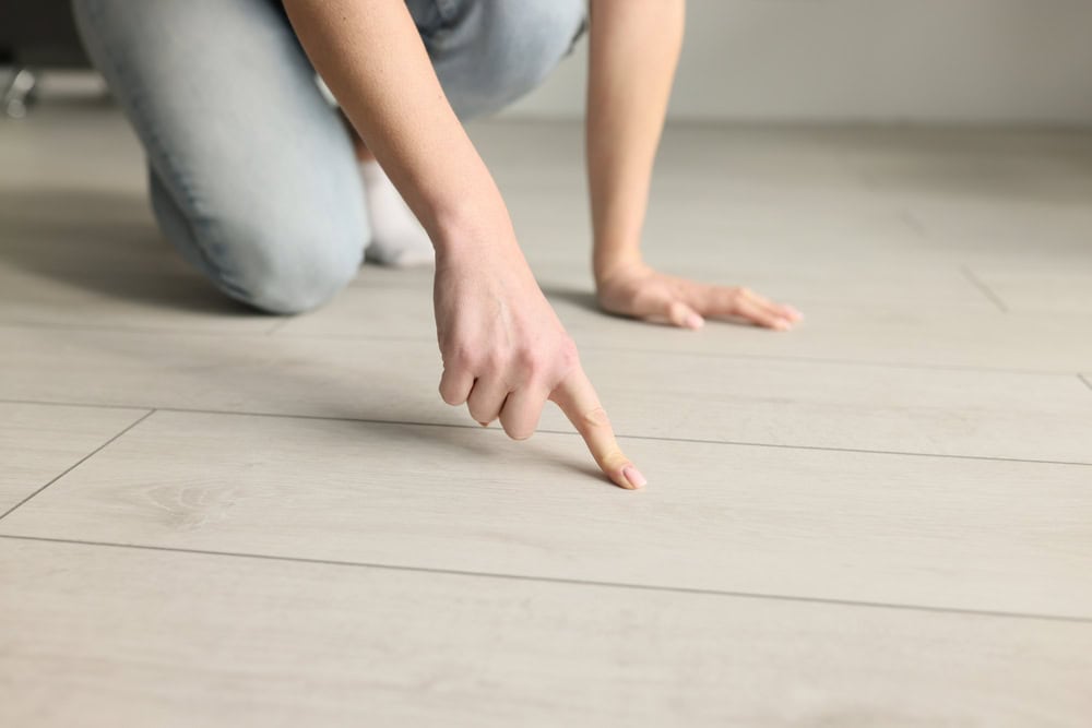 Inspecting the floor closely.
