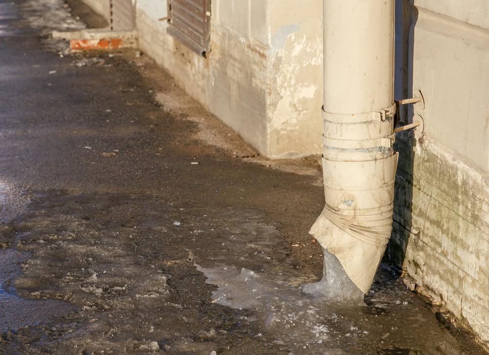 Water flows from a damaged downspout.