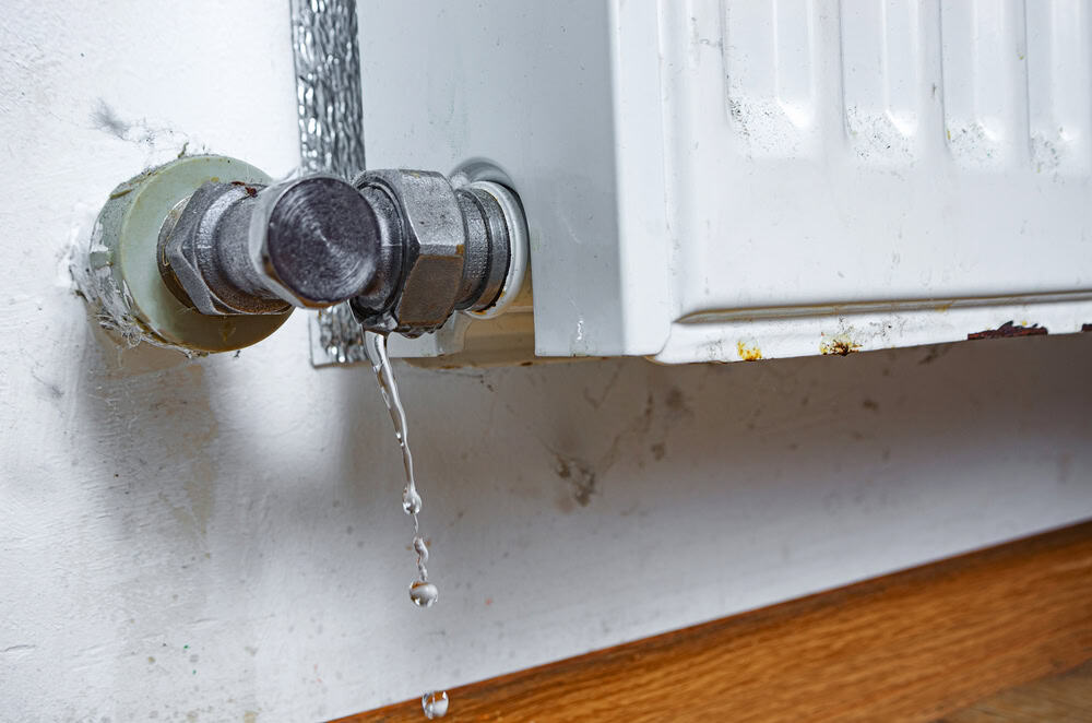 Water drips from a leaking radiator valve.