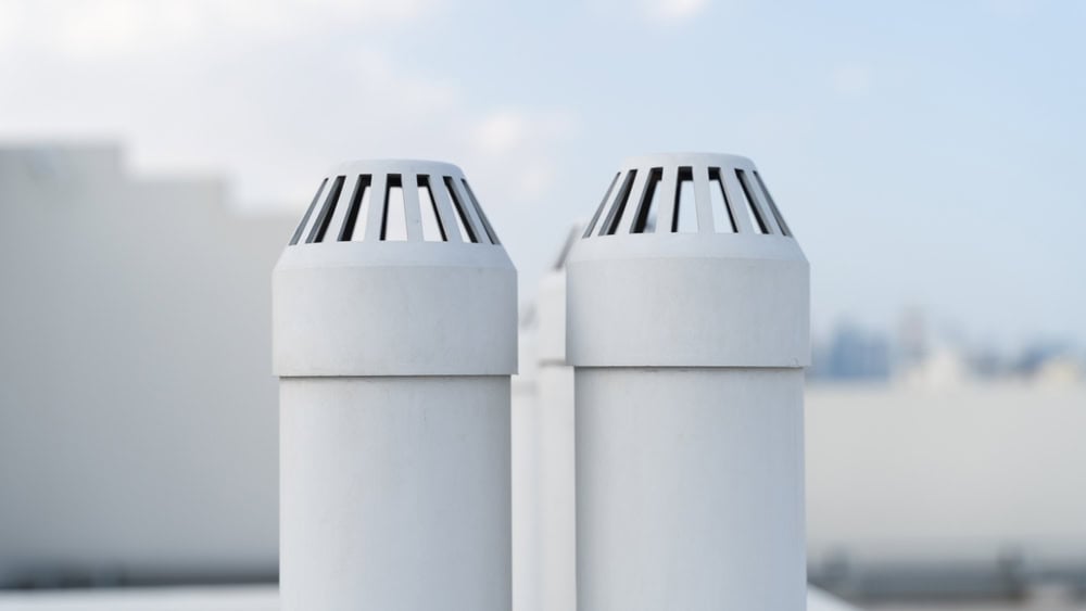 Two white rooftop vents