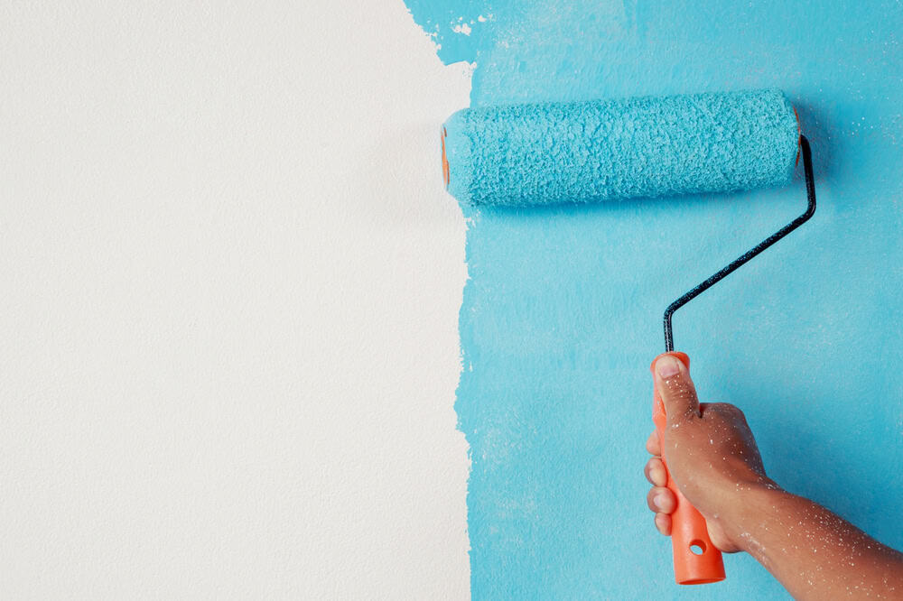Bringing color to life—transforming a blank wall with vibrant blue paint.