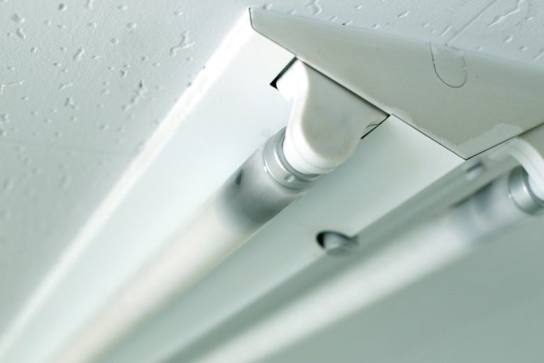 Fluorescent fixture on a textured ceiling.