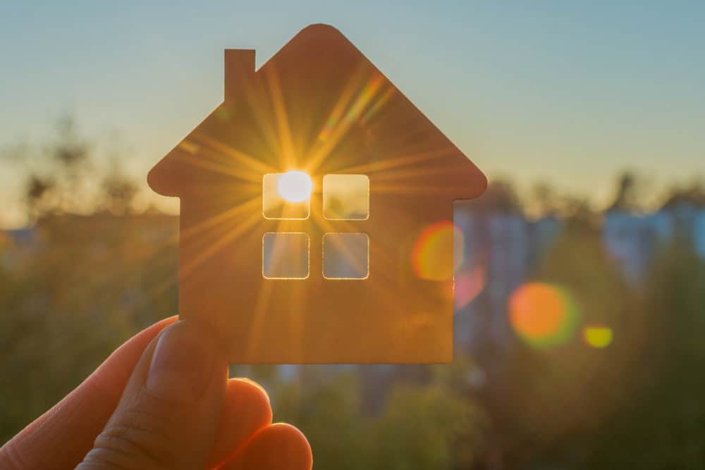 Holding onto the dream of homeownership with the sun setting in the background.
