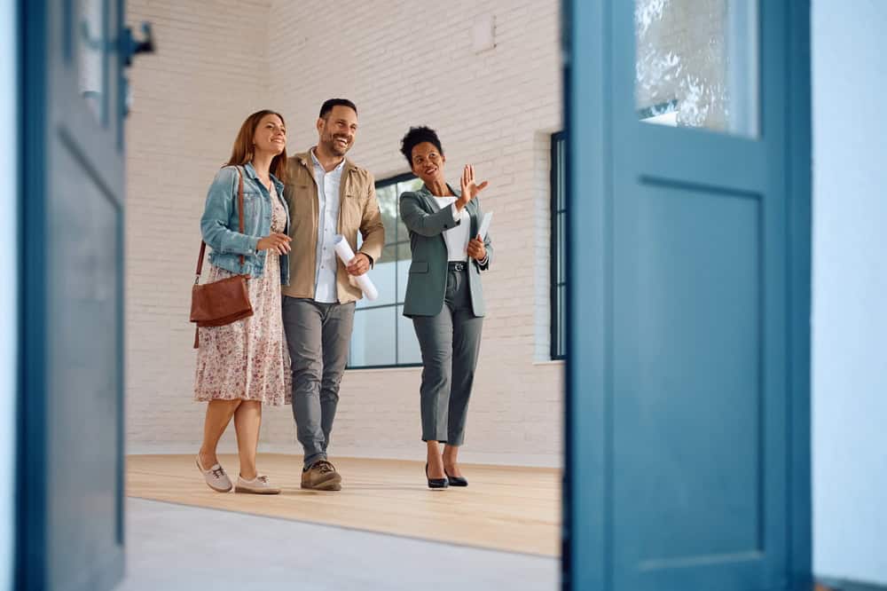 A couple explores their potential new home with a real estate agent.