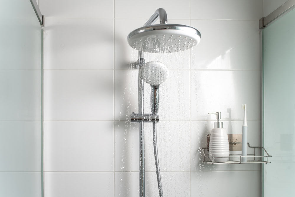 A modern shower setup with a rainfall showerhead and handheld sprayer