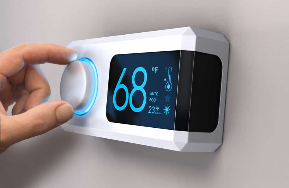 Adjusting the smart thermostat to a cozy 68°F for energy efficiency.