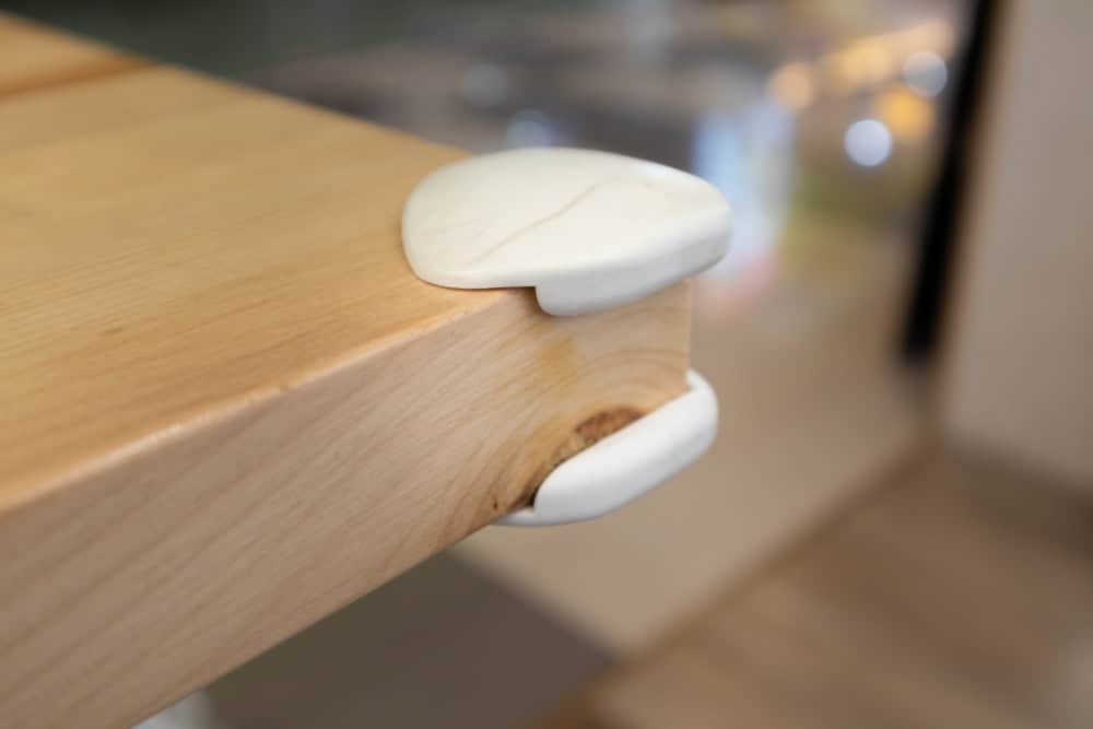Soft corner protector on a wooden table ensures safety in child-friendly spaces.