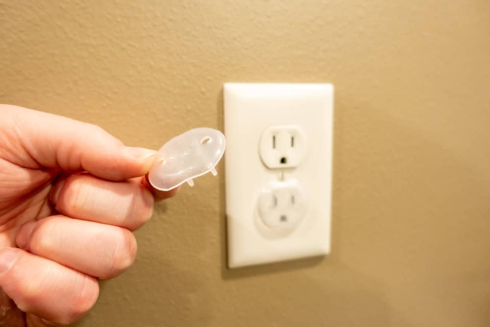 Childproofing in action — installing safety outlet cover