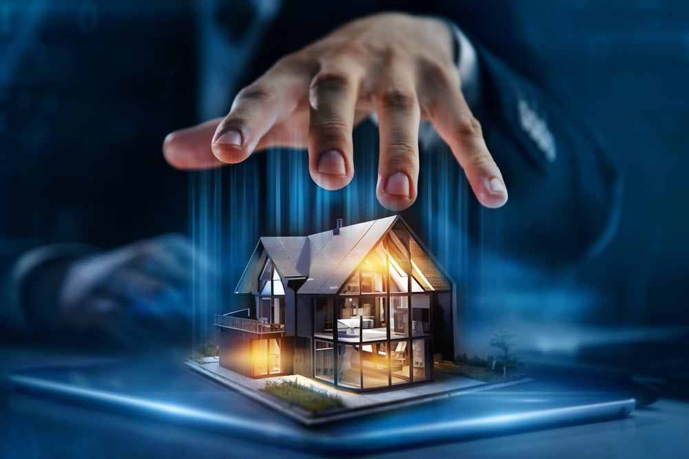 A hand hovers protectively over a digitally rendered modern house