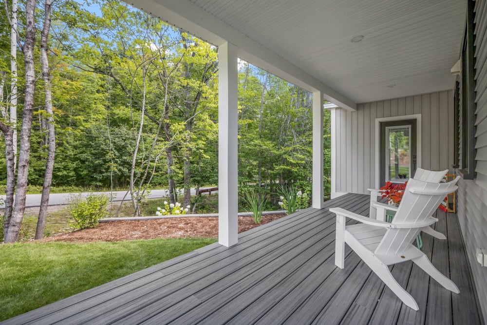 Peaceful front porch views with Adirondack chairs.