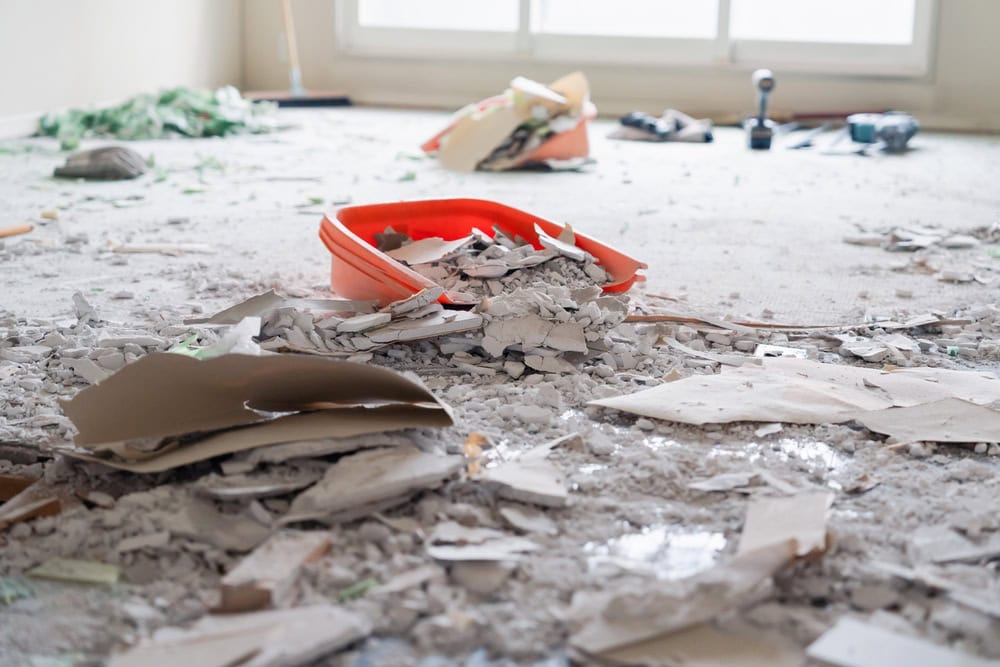 A chaotic renovation scene with debris scattered across the floor.