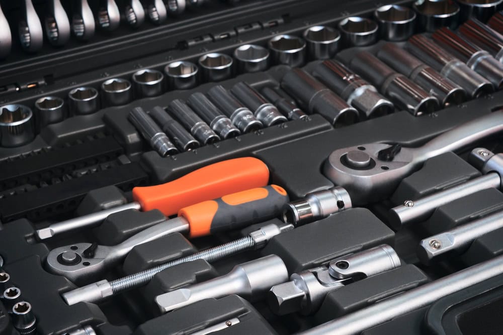 A meticulously organized toolbox filled with a variety of wrenches and sockets, ready for any mechanical challenge.