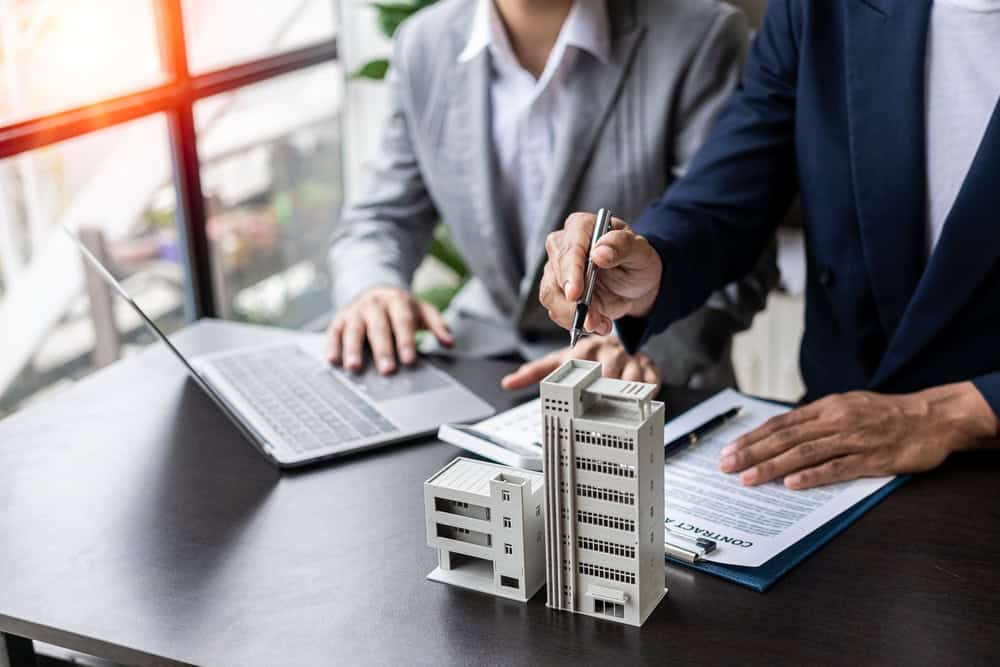 Real estate professionals finalize a property development deal.
