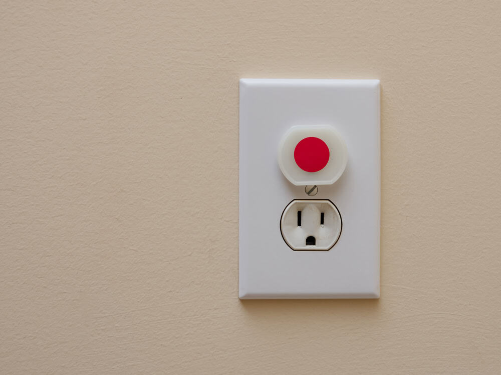 Childproof electrical outlet with safety cover securely in place.